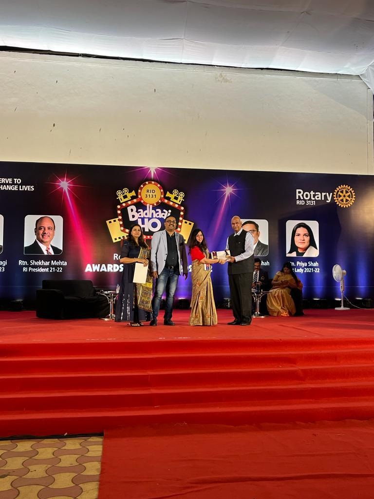 A club award being presented on stage at the District 3131 awards function