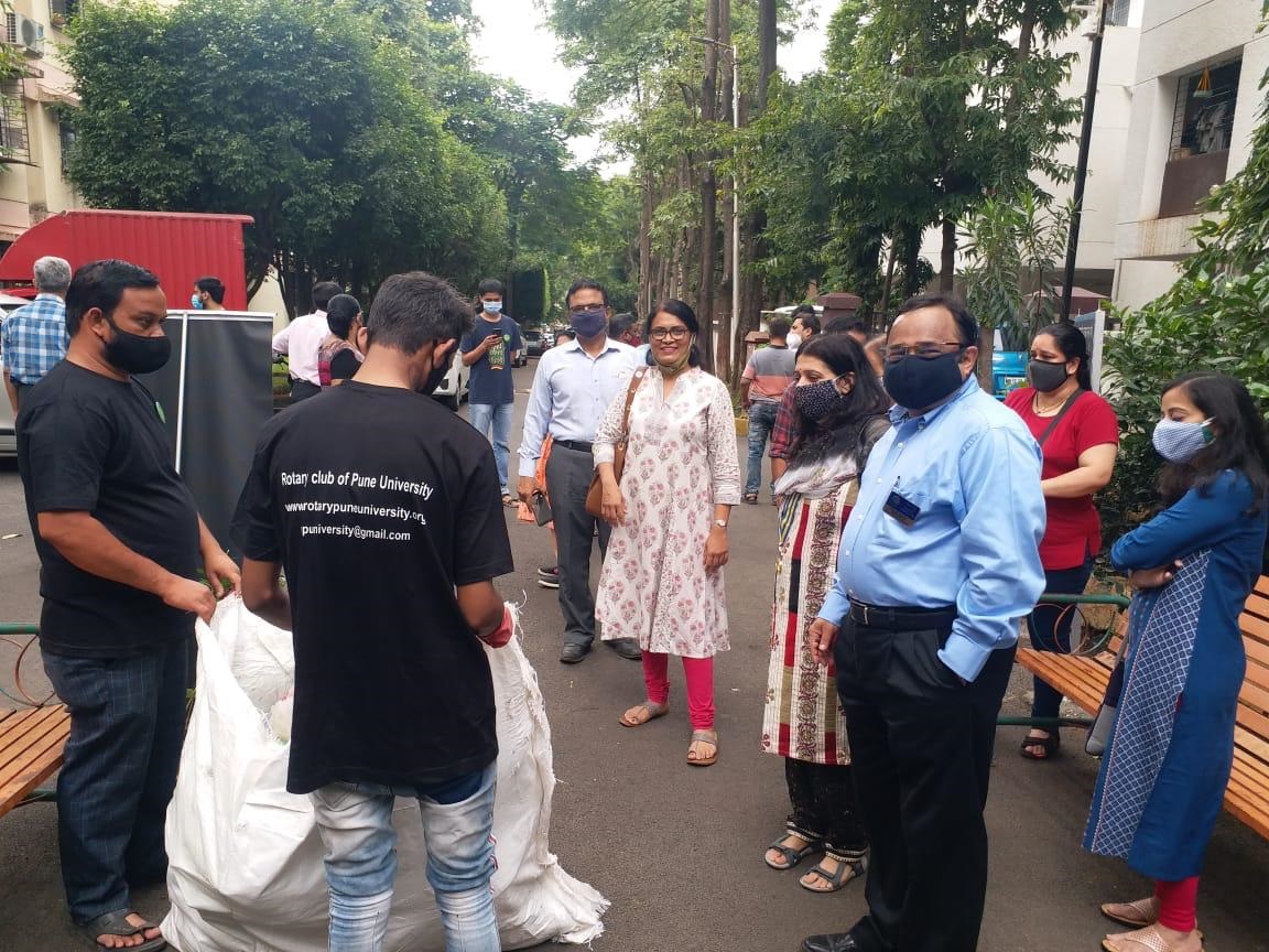 Club members and volunteers bagging collected plastic for recycling