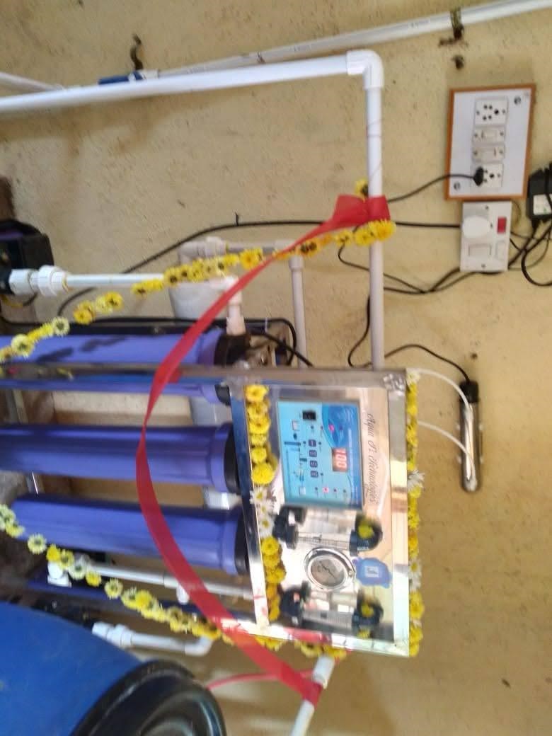 The water purification unit of the club's Water ATM, garlanded on the day it was commissioned