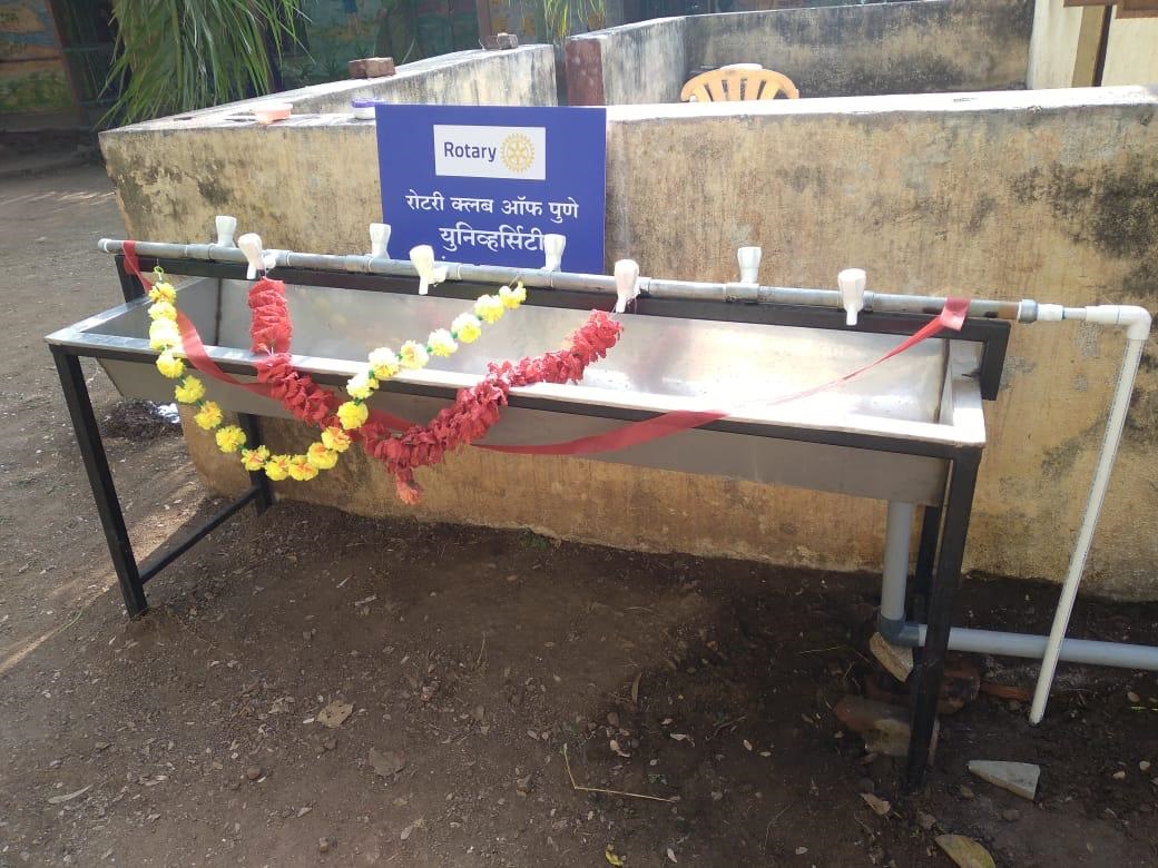 A newly built multi-tap handwash trough carrying the Rotary Club of Pune University plaque