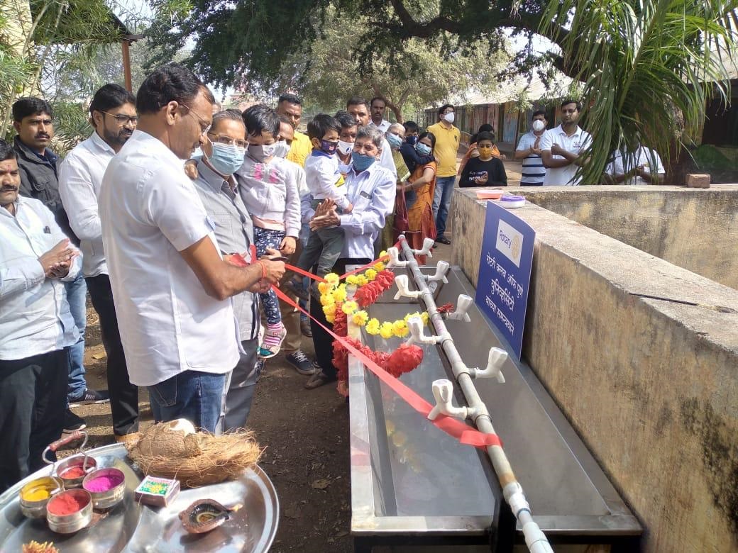 Ribbon-cutting at a village handwash station built by the club in 2021-22