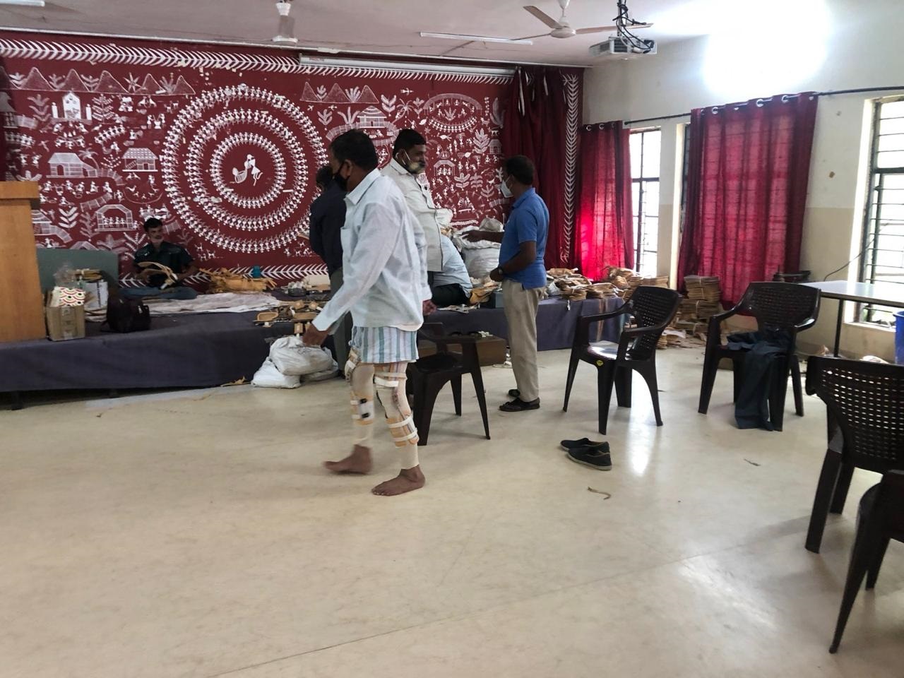 A beneficiary walking in newly fitted knee braces at the club's camp