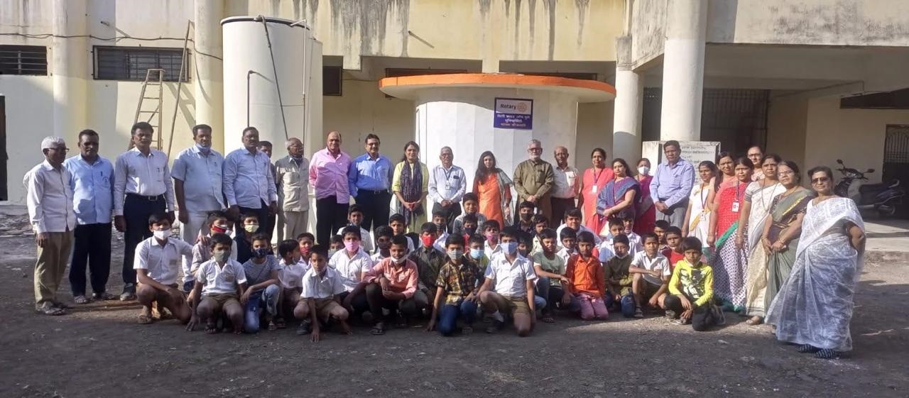 Club members and schoolchildren at the handover of the school handwash station